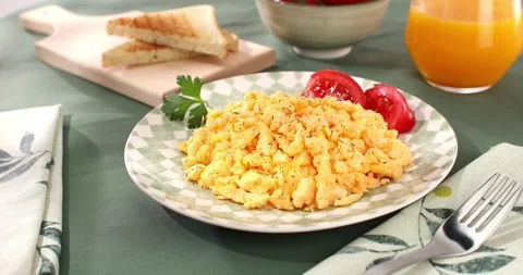 Scrambled eggs with bacon and tomato. breakfast on a plate. Stock Footage 242495155