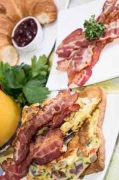 Scrambled eggs with bacon Stock Photos