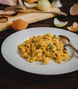 Scrambled eggs with bacon Stock Photos