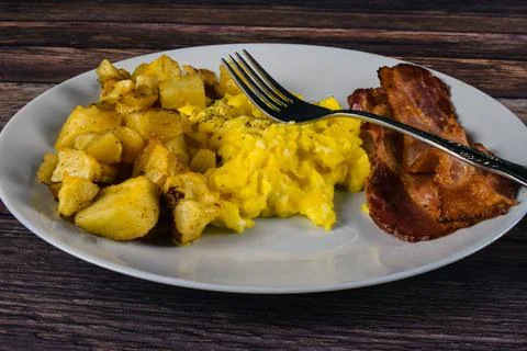 Scrambled eggs with bacon Stock Photos