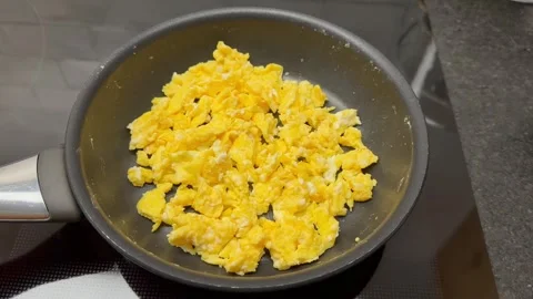 Scrambled eggs being prepared in pan Stock Footage 260312713