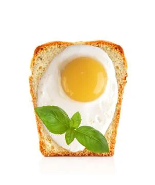 Scrambled eggs on bread with basil isolated on white Stock-Fotos