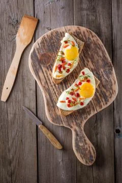 Scrambled eggs with bread on cutting board Stock Photos
