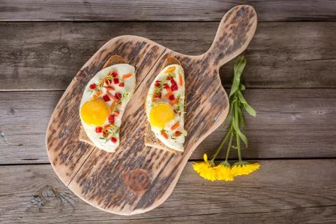Scrambled eggs with bread on cutting board Stock Photos