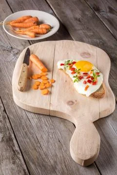 Scrambled eggs with bread on cutting board Stock Photos