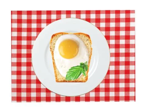 Scrambled eggs with bread on plate, on color napkin 库存照片