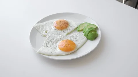 Scrambled eggs for breakfast with avocado. Proper nutrition. Natural protein Stock Footage 127782984