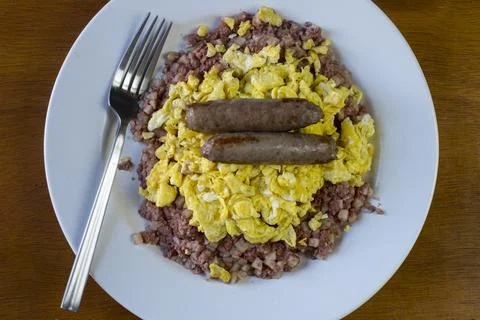 Scrambled eggs  with corn beef hash and sausage Stock Photos