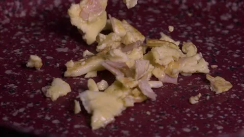 Scrambled Eggs dropping on ceramic pan slow motion 1000fps Stock Footage 148977051
