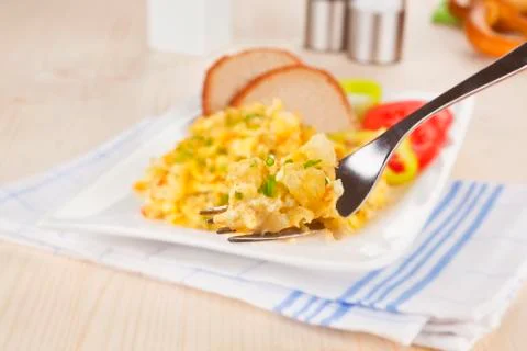 Scrambled eggs on fork. Stock Photos