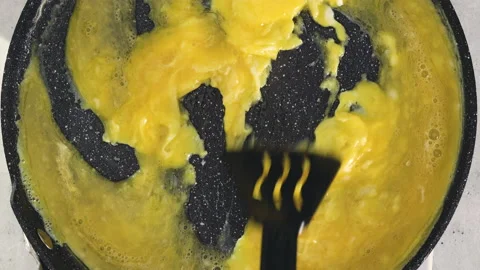 Scrambled eggs fried on a frying pan. Stock Footage 238795738