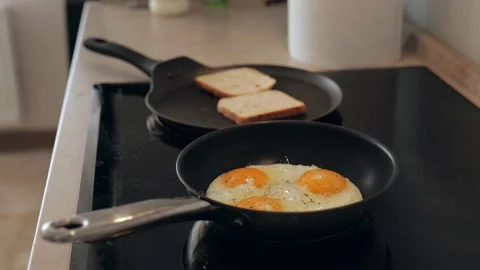 Scrambled eggs fried in a pan. three egg breakfast. 4k video. slow motion Stock Footage 219454601