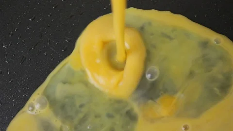 Scrambled eggs in a frying pan for breakfast top view Video stock 120236126