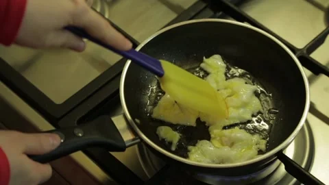 Scrambled-eggs-in-a-frying-pan Stock Footage 144314662