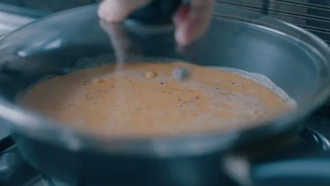Scrambled eggs frying in a pan, then somebody putting the lid on it Video stock 71927405