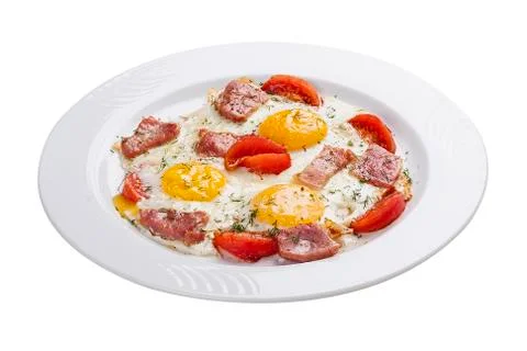 Scrambled eggs with ham and tomatoes on a white plate Stock Photos
