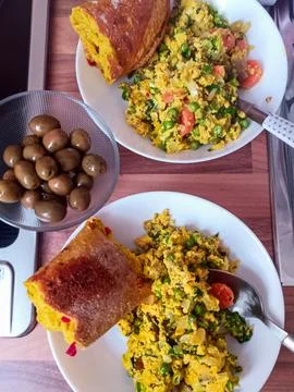 Scrambled Eggs with Olives Served on Dining Table 스톡 사진