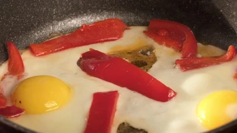 Scrambled eggs, omelette. Cooking breakfast with pan-fried eggs. Preparing food Stock Footage 182245548