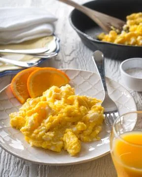 Scrambled Eggs with Orange Slices Stock Photos