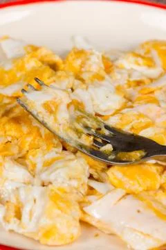 Scrambled eggs on the plate with fork Stock Photos