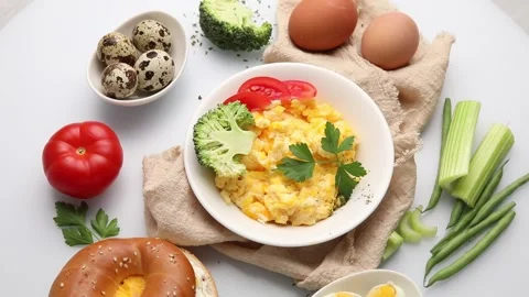 Scrambled eggs on plate over white background. Top view, flat lay Stock Footage 171240465