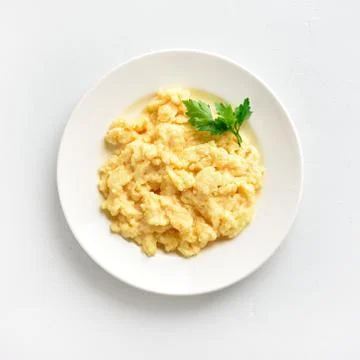 Scrambled eggs on plate Stock Photos
