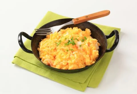 Scrambled eggs ready in a pan Stock Photos