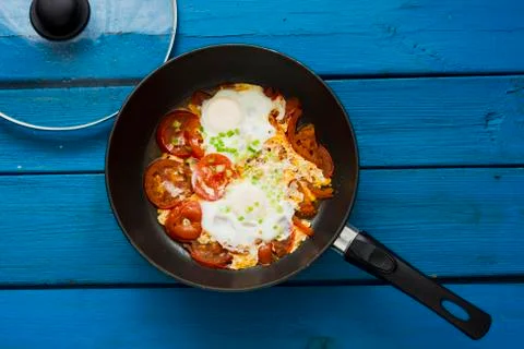 Scrambled eggs with red tomatoes Stock Photos