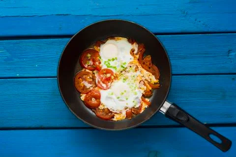 Scrambled eggs with red tomatoes Stock Photos