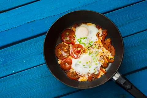 Scrambled eggs with red tomatoes Stock Photos