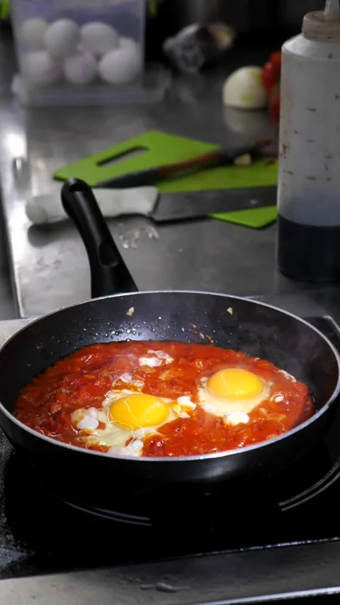 Scrambled eggs in a sauce of fresh tomatoes, sweet or hot peppers, onions and Stock Footage 314124641