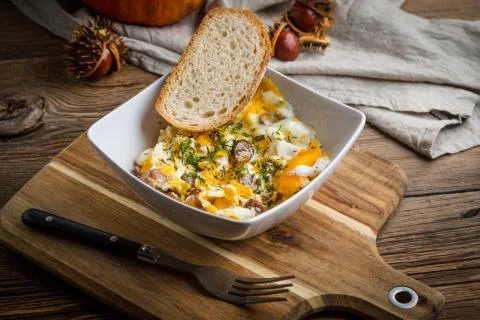 Scrambled eggs with sausage and bread. Stock Photos