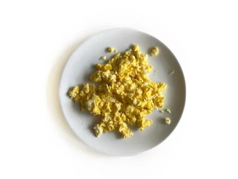 Scrambled eggs served on a white round plate Stock Photos