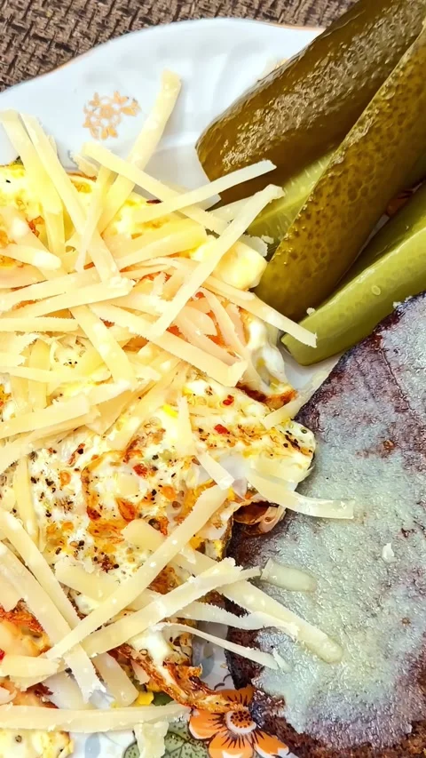 Scrambled Eggs with Shredded Cheese and Pickles on Buttered Rye Bread Stock Footage 339751990