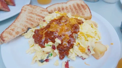Scrambled Eggs Skillet Breakfast topped with Chili and Melted Cheese Stock Footage 345927444