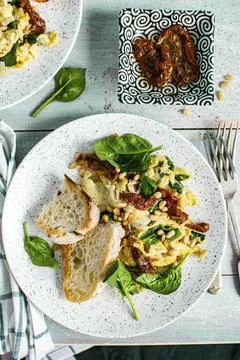Scrambled eggs with spinach and sun dried tomato food photography Stock Photos