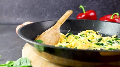 Scrambled eggs with spinach in a pan Stock Footage 145986902
