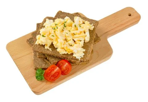 Scrambled eggs on toast with cherry tomatoes Stock Photos