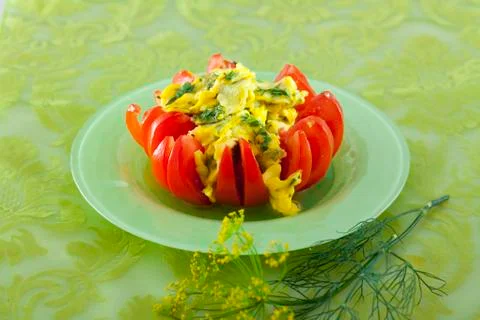 Scrambled eggs in tomato Stock Photos