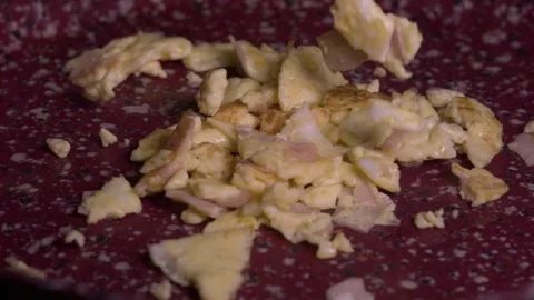 Scrambled Eggs with turkey ham dropping on ceramic pan slow motion 1000fps Stock Footage 148977591