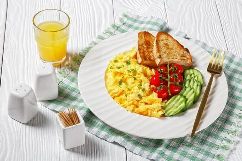 Scrambled eggs with veggies and bread on a plate Stock Photos