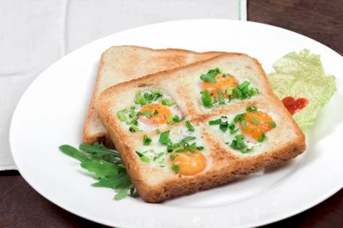Scrambled quail eggs and bread in the shape of 4 hearts (like lucky clover) Stock Photos