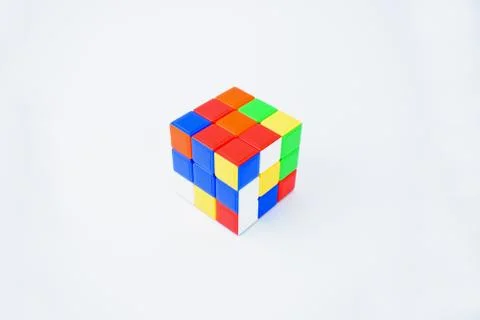 A scrambled Rubik cube isolated on a white background displaying various colo Stock Photos