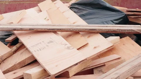 Scrap Lumber Thrown Into Construction Dumpster on Job Site Stock Footage 345240756
