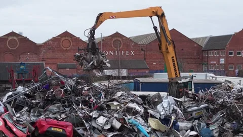 Scrap metal dealership with crane loading a truck with junk Video stock 306321153