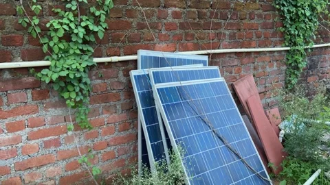 Scrap solar panels by the wall Stock Footage 313917892