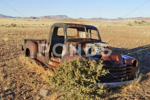 Scrap Vehicle At The Edge Of The Desert, Naukluft Mountains At Back, Republic