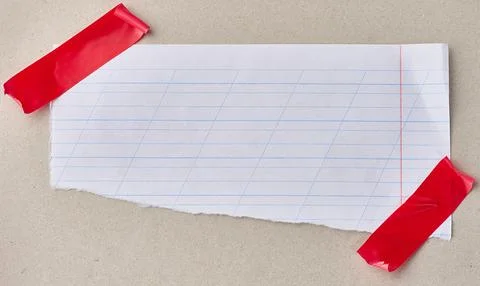 A scrap of white notebook paper with diagonal lines, attached with red elec.. Stock Photos
