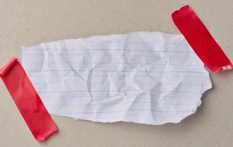 A scrap of white notebook paper with diagonal lines, attached with red elec.. Stock Photos