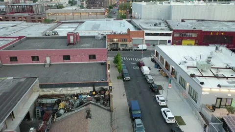 Scrap yard behind warehouse roofs in East Williamsburg Brooklyn Stock Footage 154433420